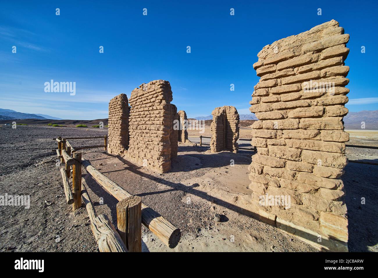 Sandy desert with abandoned and decayed stone structure Stock Photo