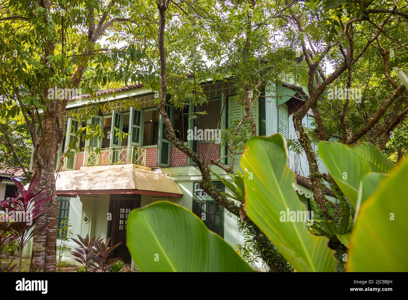 Langkawi, Malaysia - June 7, 2022: Traditional Malay wooden house between tropical vegetation. Typical Malaysian stilt house. Wood architecture cools Stock Photo