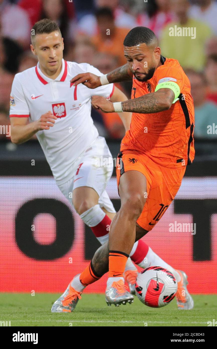 Rotterdam, Netherlands. 11th June, 2022. Memphis Depay (R) of the Netherlands vies with Przemyslaw Frankowski of Poland during the UEFA Nations League league A football match between the Netherlands and Poland in Rotterdam, the Netherlands, on June 11, 2022. Credit: Zheng Huansong/Xinhua/Alamy Live News Stock Photo