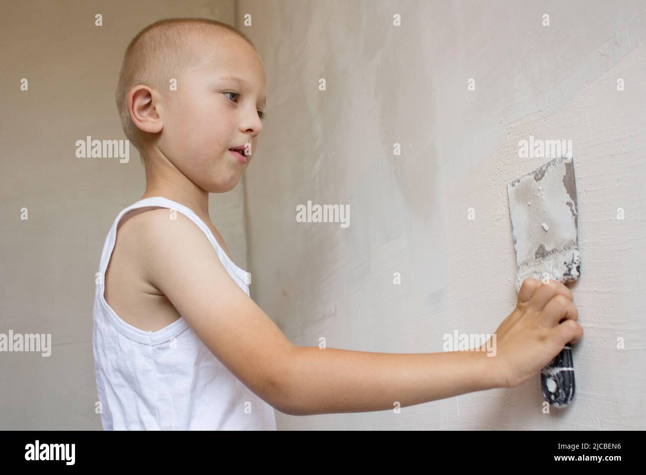 man hand with trowel plastering a wall, skim coating plaster walls