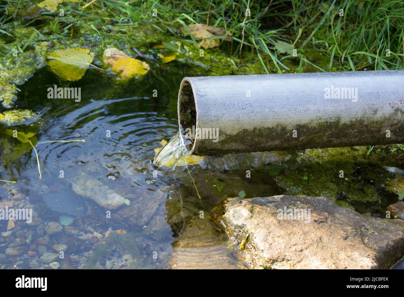 water pipes spring, clean water spring flows from a pipe Stock Photo