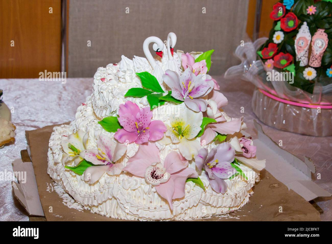 White wedding cake with orange and green flowers Stock Photo