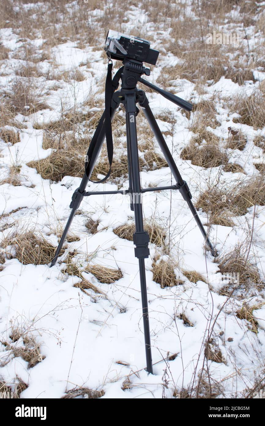 winter in nature tripod the camera shoots video story Stock Photo
