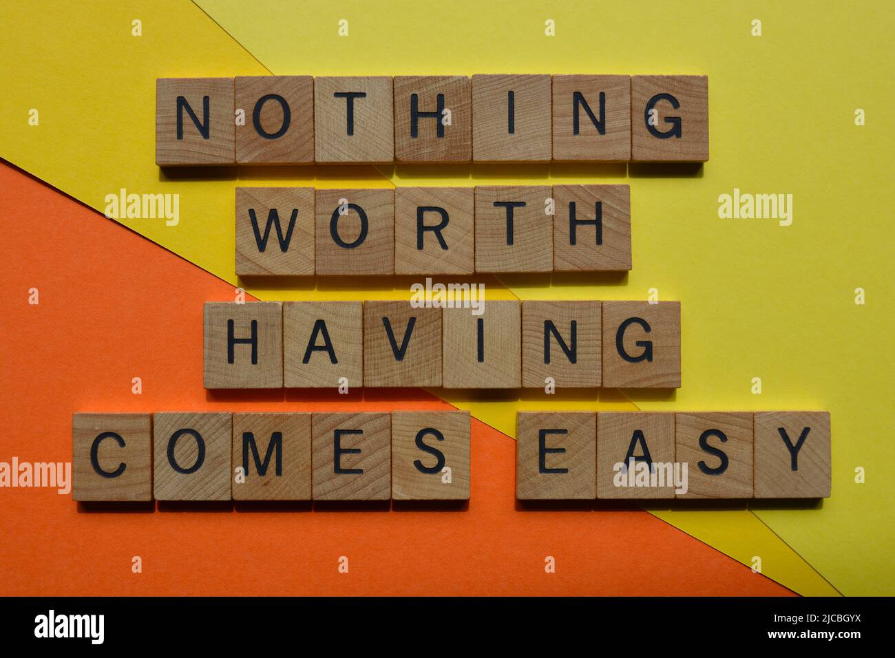 Nothing Worth Having Comes Easy, words in wooden alphabet letters isolated on background Stock Photo