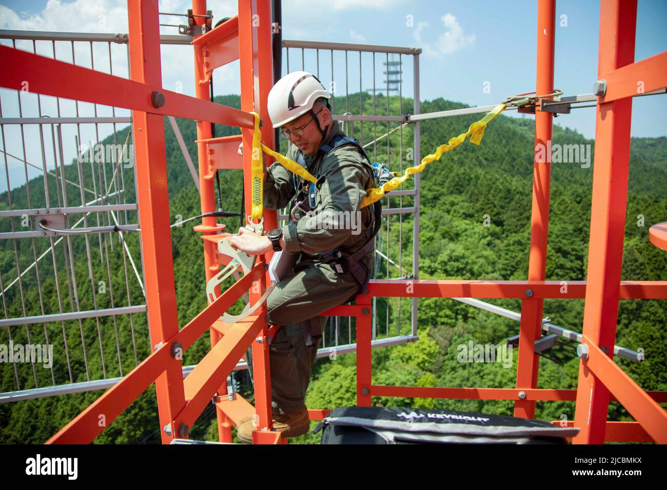 Iwakuni, Yamaguchi, Japan. 25th May, 2022. U.S. Marine Corps Lance Cpl. Xinxin Dai, an air traffic control communications technician, attaches a harness to a radio tower in Yamaguchi Prefecture, Japan, May 17, 2022. Marine Corps Air Station Iwakuni's radio towers are maintained weekly because of their vital role in the communication and safety between several units at the air station. Due to the geographic scope of the Indo-Pacific Command area of responsibility MCAS Iwakuni serves as a vital link between multiple countries in the Western Pacific theater. (Credit Image: © U.S. Marines/ZUMA P Stock Photo