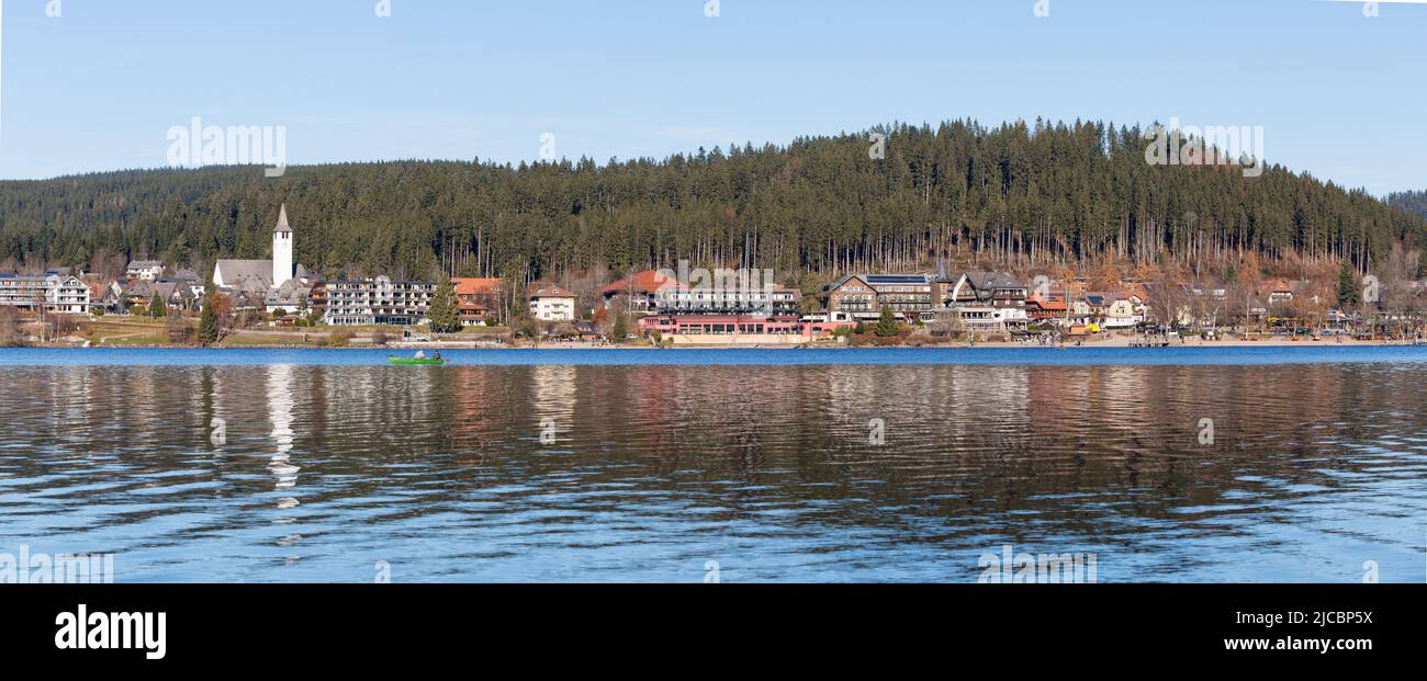 Titisee, Germany - Nov 21, 2021: Panorama of the town of Titisee with lake in the foreground. Popular tourist destination in the black forest. Stock Photo