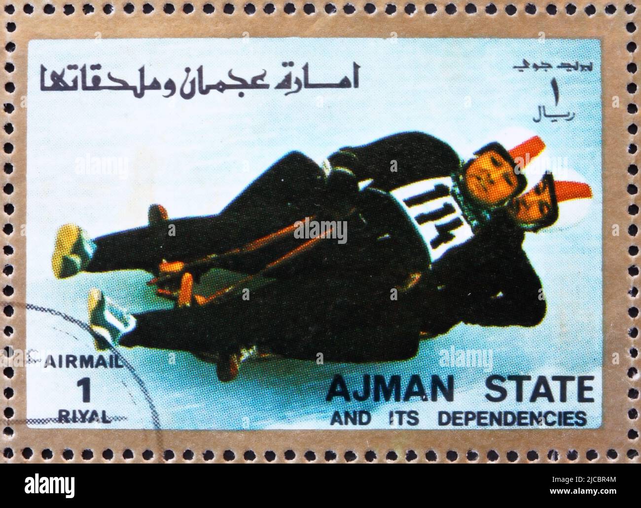 AJMAN - CIRCA 1973: a stamp printed in the Ajman shows Two-man Sledge, Winter Olympics, circa 1973 Stock Photo