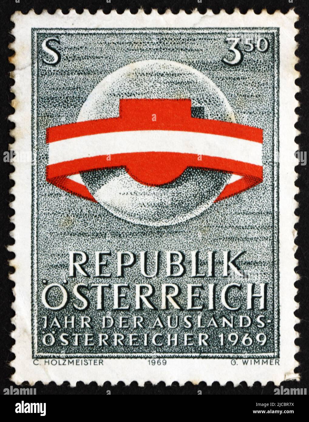 AUSTRIA - CIRCA 1969: a stamp printed in the Austria shows Austria's Flag and Shield Circling the World, Year of Austrians Living Abroad, circa 1969 Stock Photo