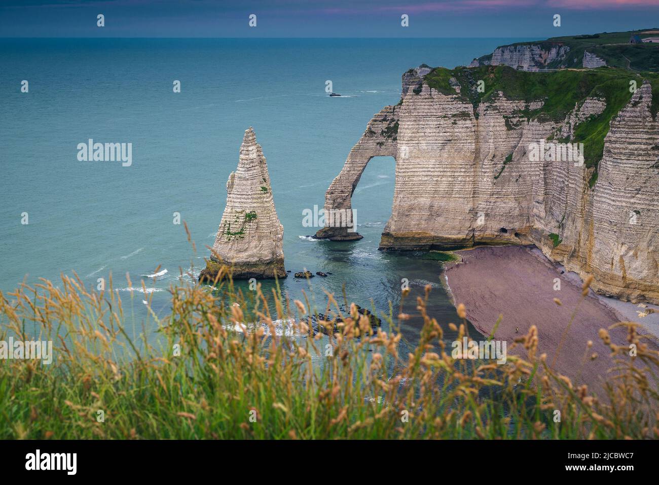 Stunning seaside landscape with majestic high cliffs and green slopes, Etretat, Normandy, France, Europe Stock Photo