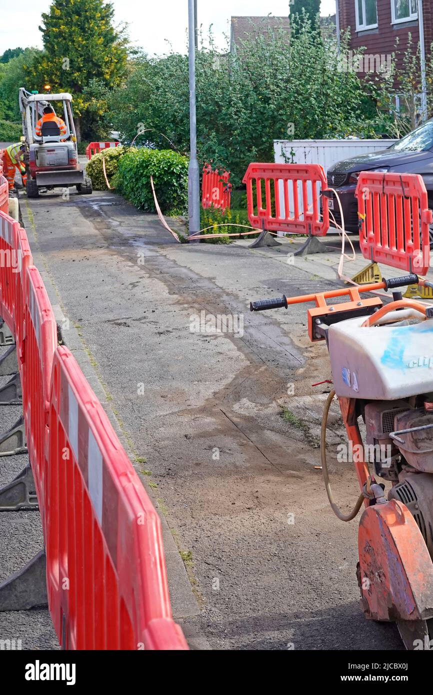 Fibre optic super fast broadband infrastructure project rural Essex village pavement work starts on cutting out shallow cable trench outside homes UK Stock Photo