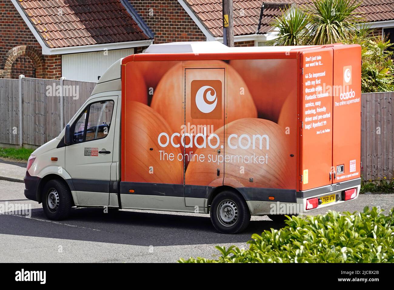 Side & back view Mercedes Ocado online retail grocery business food shopping delivery van & logo driving at Essex village road junction England UK Stock Photo