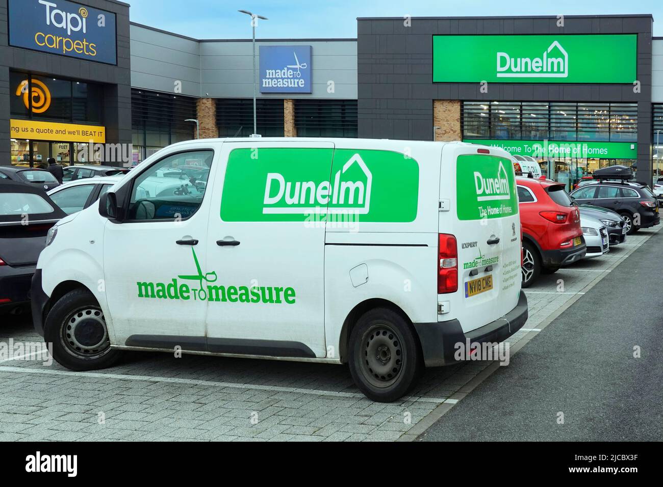 Peugeot Expert van in retail park outside retail shop units Dunelm business logo brand for made to measure curtain service Chelmsford Essex England UK Stock Photo
