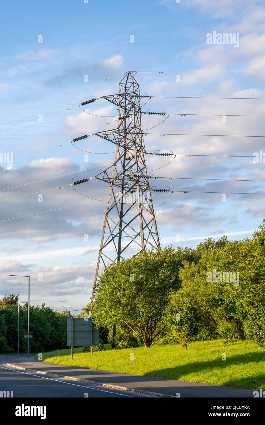 Large electrical supply pylon photographed against a blue sky Stock Photo