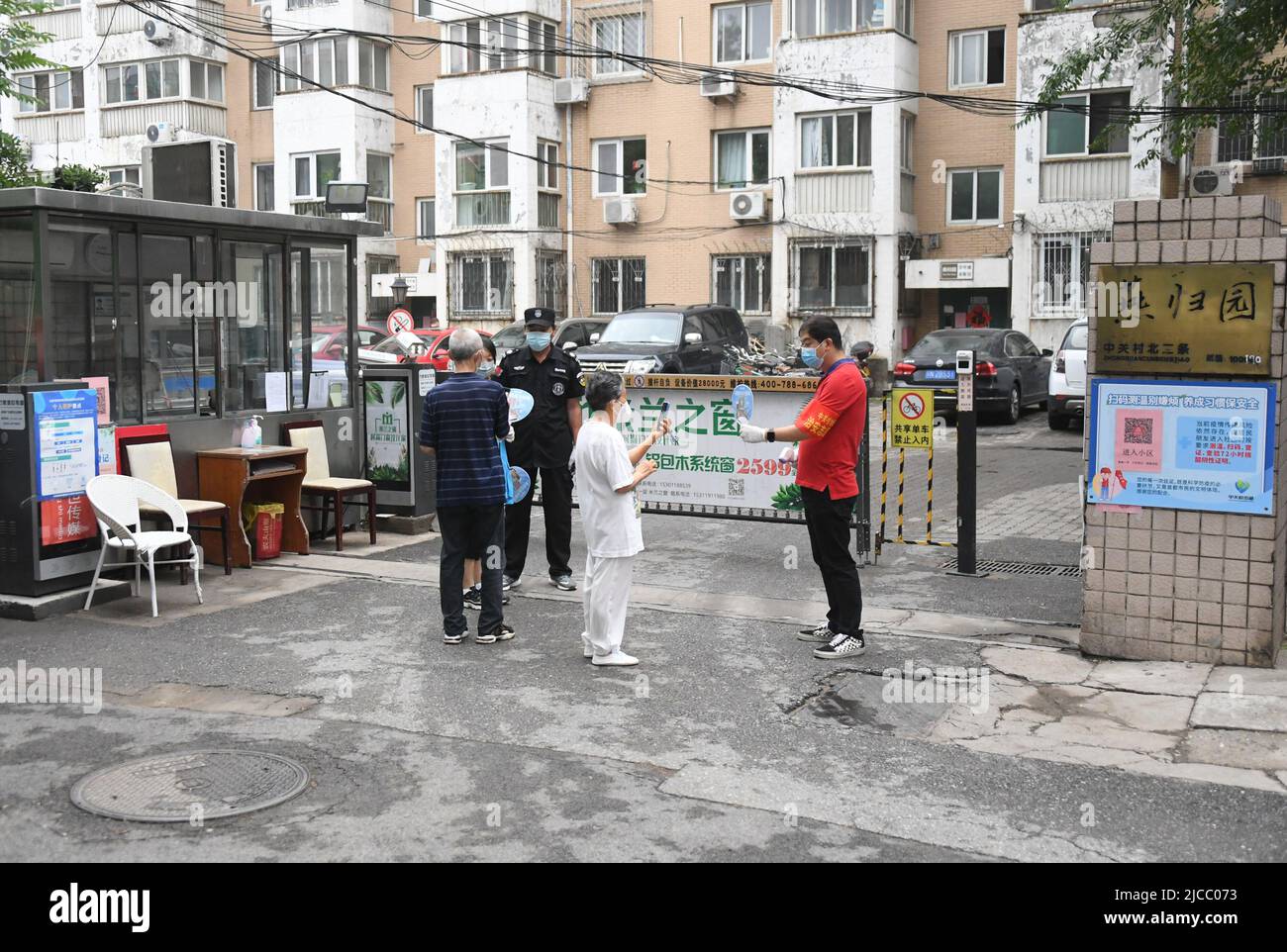 Beijing, China. 12th June, 2022. Residents scan QR codes to have their
