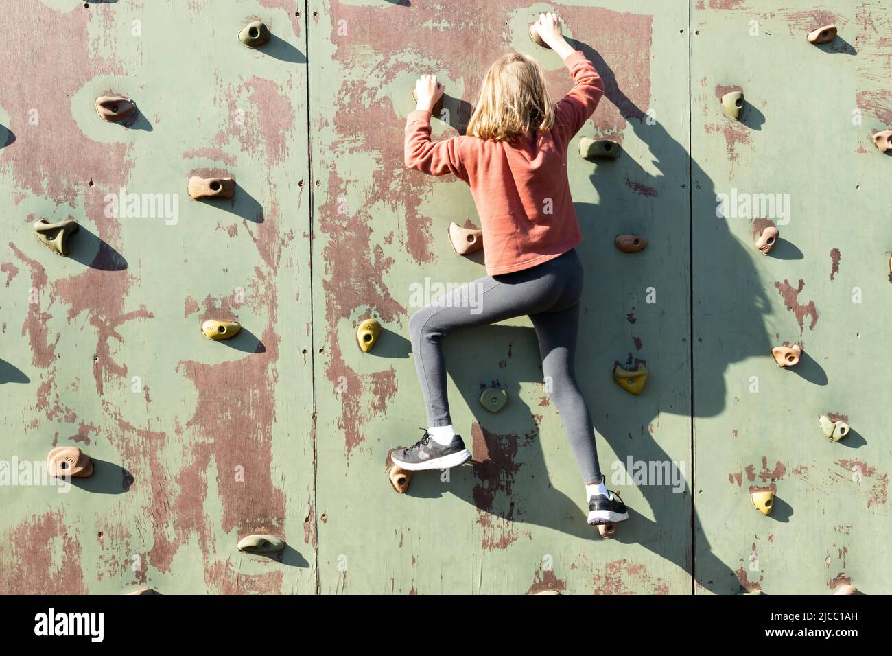 Little girl climbing on wall hires stock photography and images Alamy