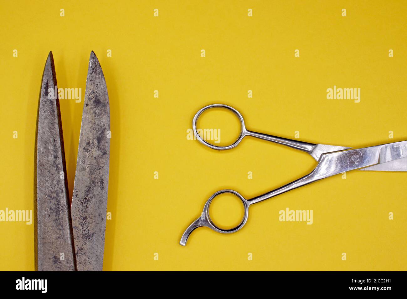 Old scissors on a yellow background Stock Photo