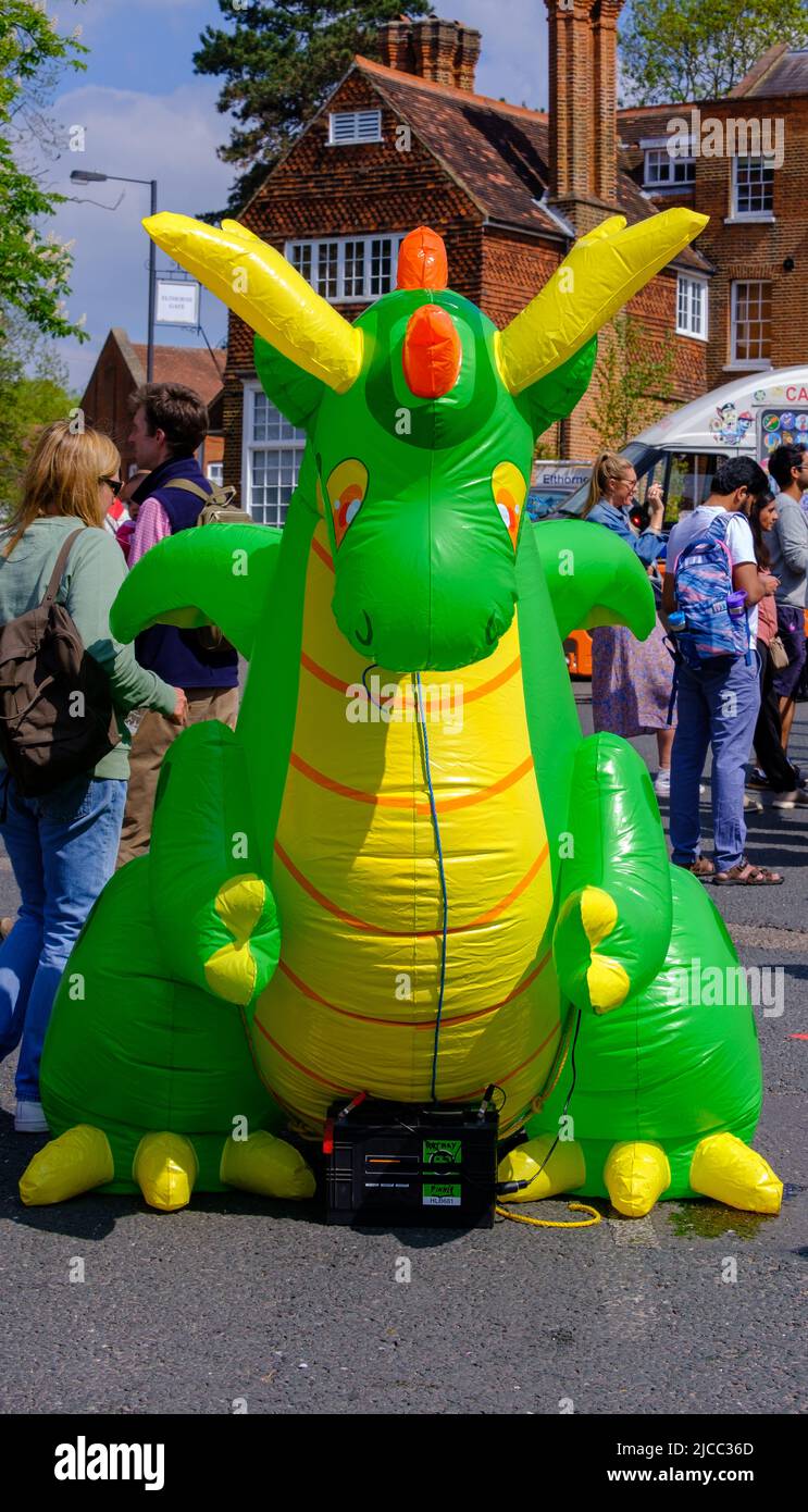 A large inflatable green & yellow dragon at the top of the High Street in Pinner at St George’s Day Celebration 2022. Northwest London. Stock Photo