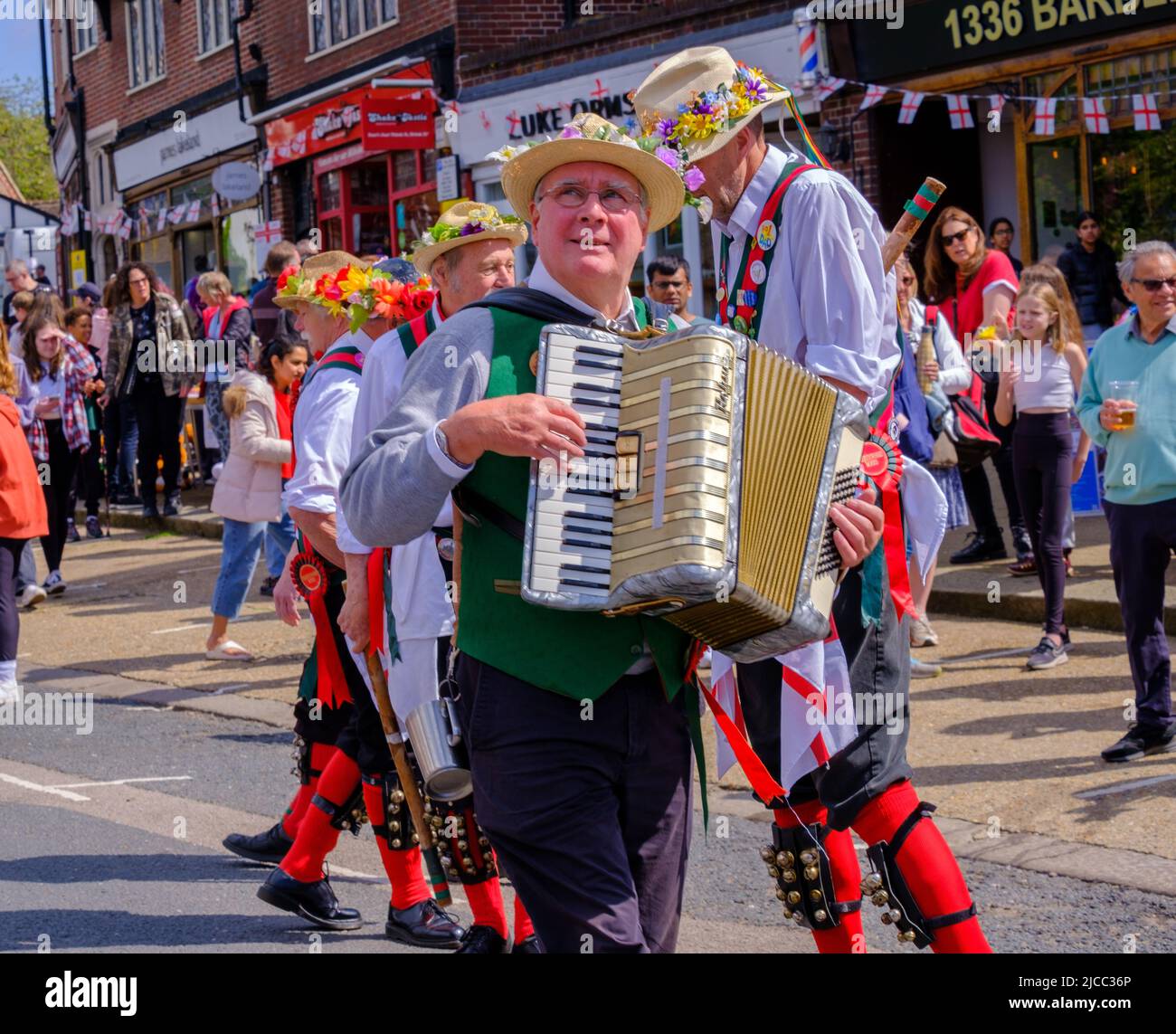 Merrydowners Morris dancer plays accordion while others dance on Pinner