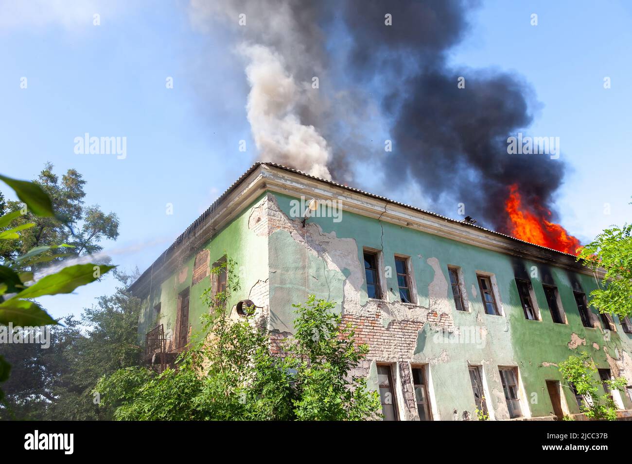 A fire on the roof of an old abandoned building Stock Photo - Alamy