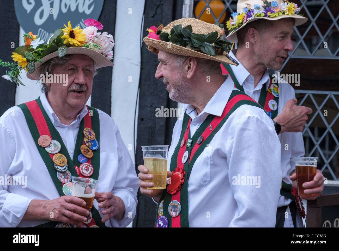 Merrydowners Morris dancers drink beer and socialise outside during St George’s Day Celebration 2022, Pinner, Northwest London Stock Photo