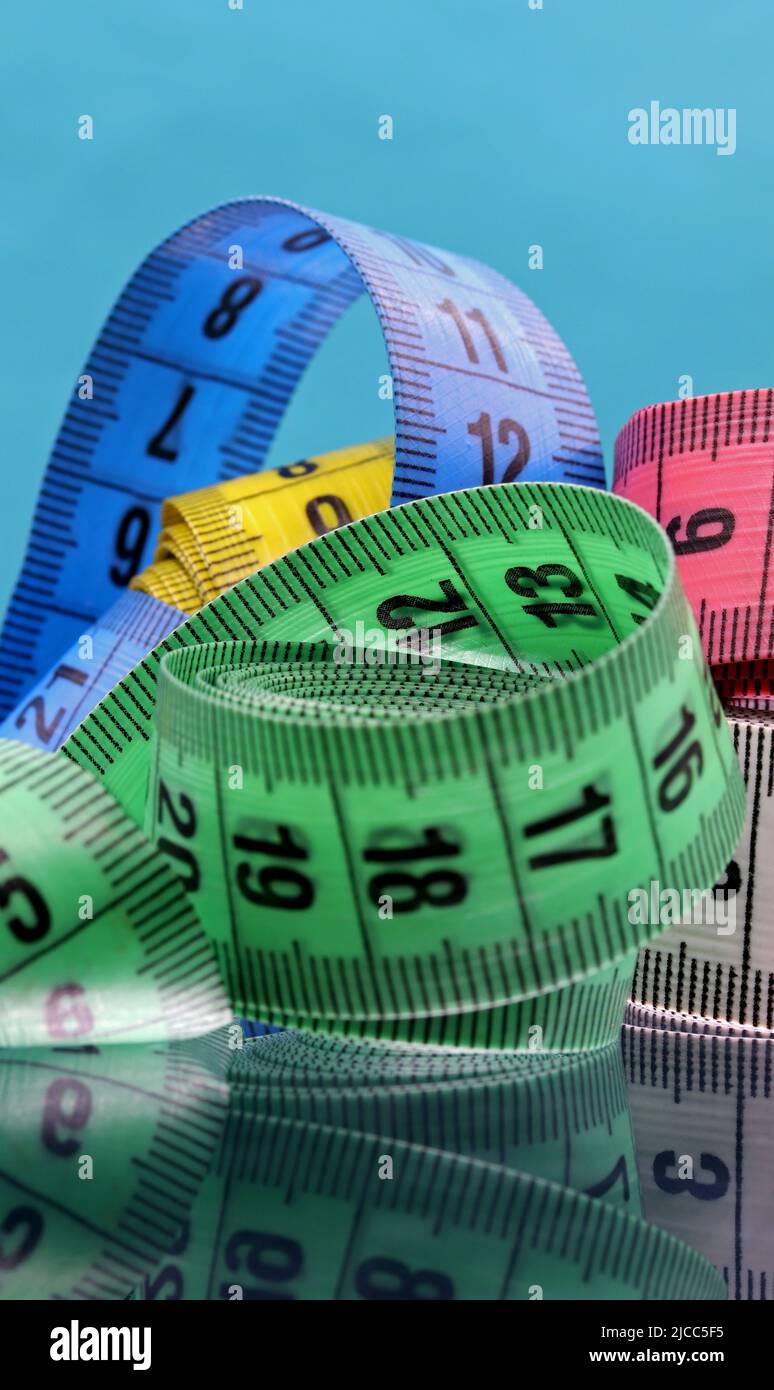 colorful measuring tapes top view on bright red background Stock Photo by  ilonadesperada