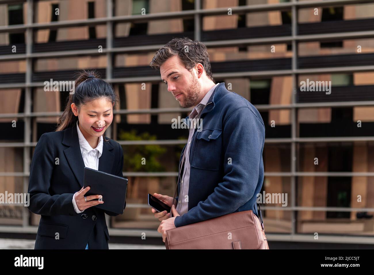 young businesswoman shows tablet to a businessman Stock Photo