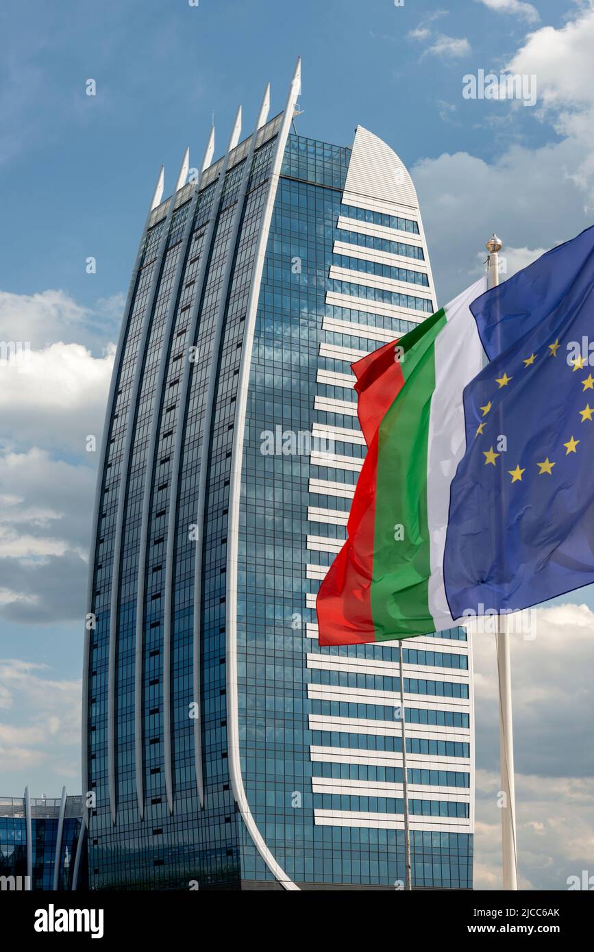 The European Union and Bulgarian national flags flying at Capital Fort modern glass office building in Sofia Bulgaria, Europe Stock Photo