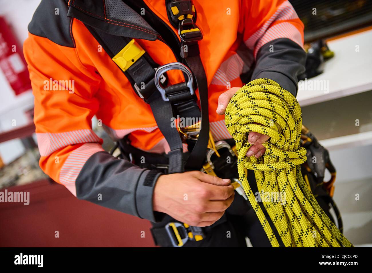 detail of the hands of a climber with the safety rope in hand Stock Photo