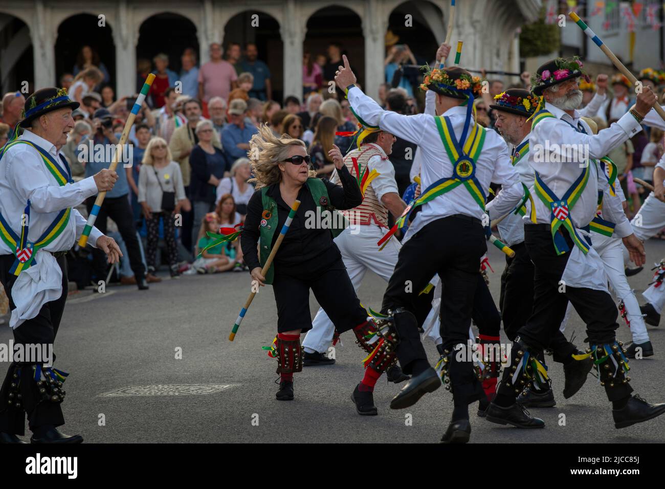 Thaxted, Essex, UK. 11th June 2022.  Sam Harker of the Baldock Midnight Morris on left battles with members of the Peterborough side during massed dancing on Town Street Thaxted. A meeting of member clubs of the Morris Ring celebrating the 90th anniversary of the founding of the Thaxted Morris Dancing side or team in Thaxted, North West Essex, England UK.  In the late afternoon all the sides congregate in Thaxted where mas Credit: BRIAN HARRIS/Alamy Live News Stock Photo