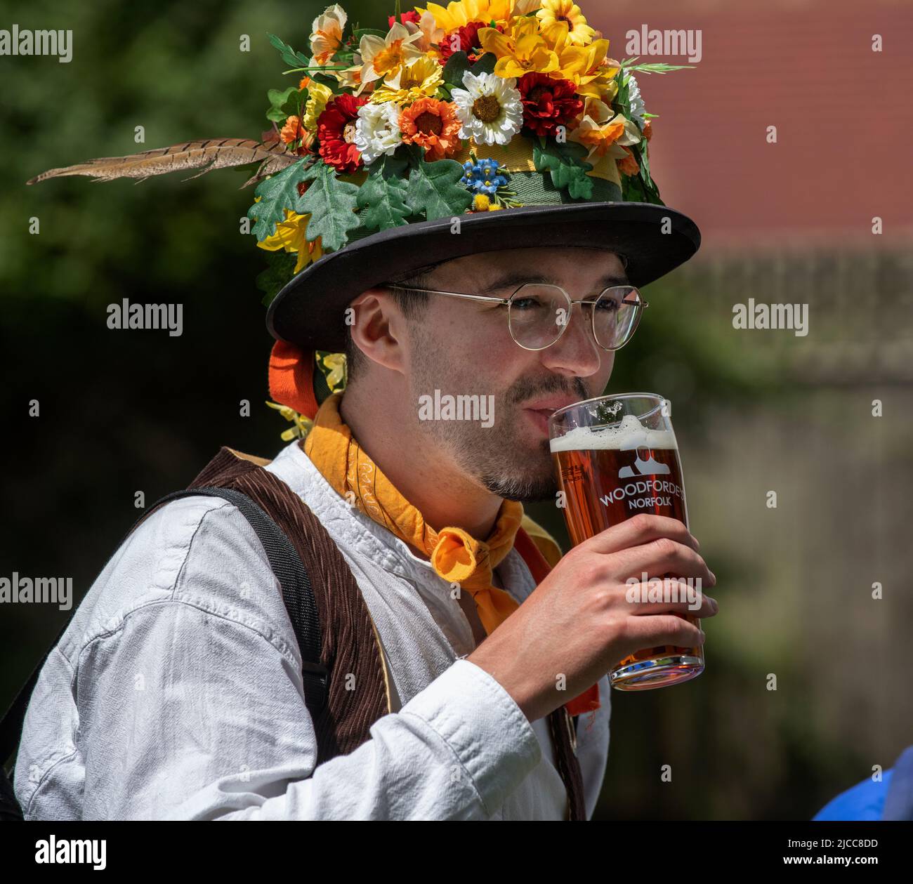 Thaxted, Essex, UK. 11th June 2022.  A member of the Chelmsford Mens Moriis side enjoys a pint at the Horse and Groom pub, Cornish Hall End, Essex Fourteen Morris Dancing sides danced through 14 villages in north west Essex for the first time since Covid restrictions were lifted for the Thaxted Morris Weekend. The evening concluded just after 10pm when Credit: BRIAN HARRIS/Alamy Live News Stock Photo