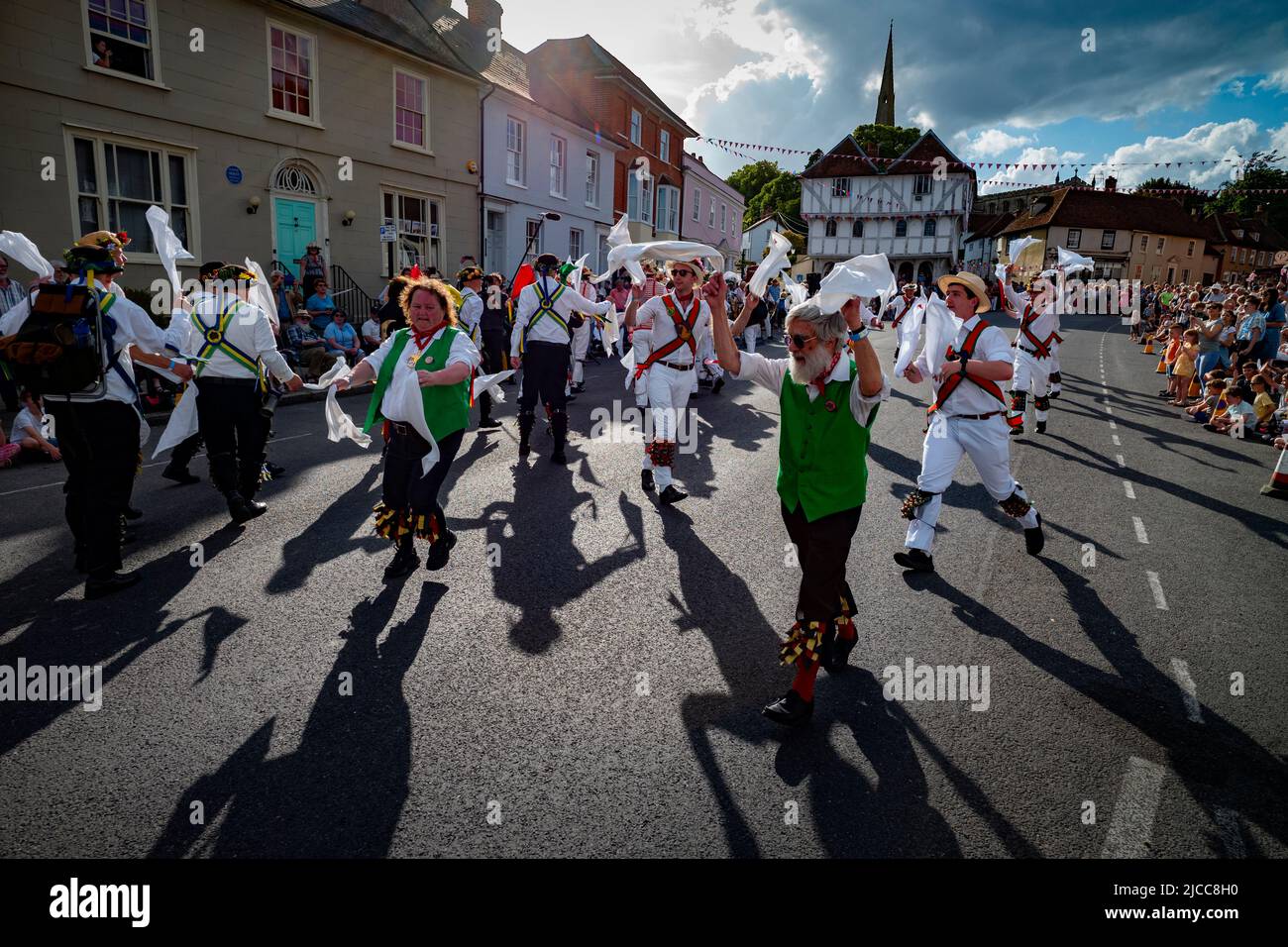 Thaxted, Essex, UK. 11th June 2022.  The early evening massed dancing through Town Street Thaxted with Thaxted Guildhall providing a 14th century backdrop. Fourteen Morris Dancing sides danced through 14 villages in north west Essex for the first time since Covid restrictions were lifted for the Thaxted Morris Weekend. The evening concluded just after Credit: BRIAN HARRIS/Alamy Live News Stock Photo