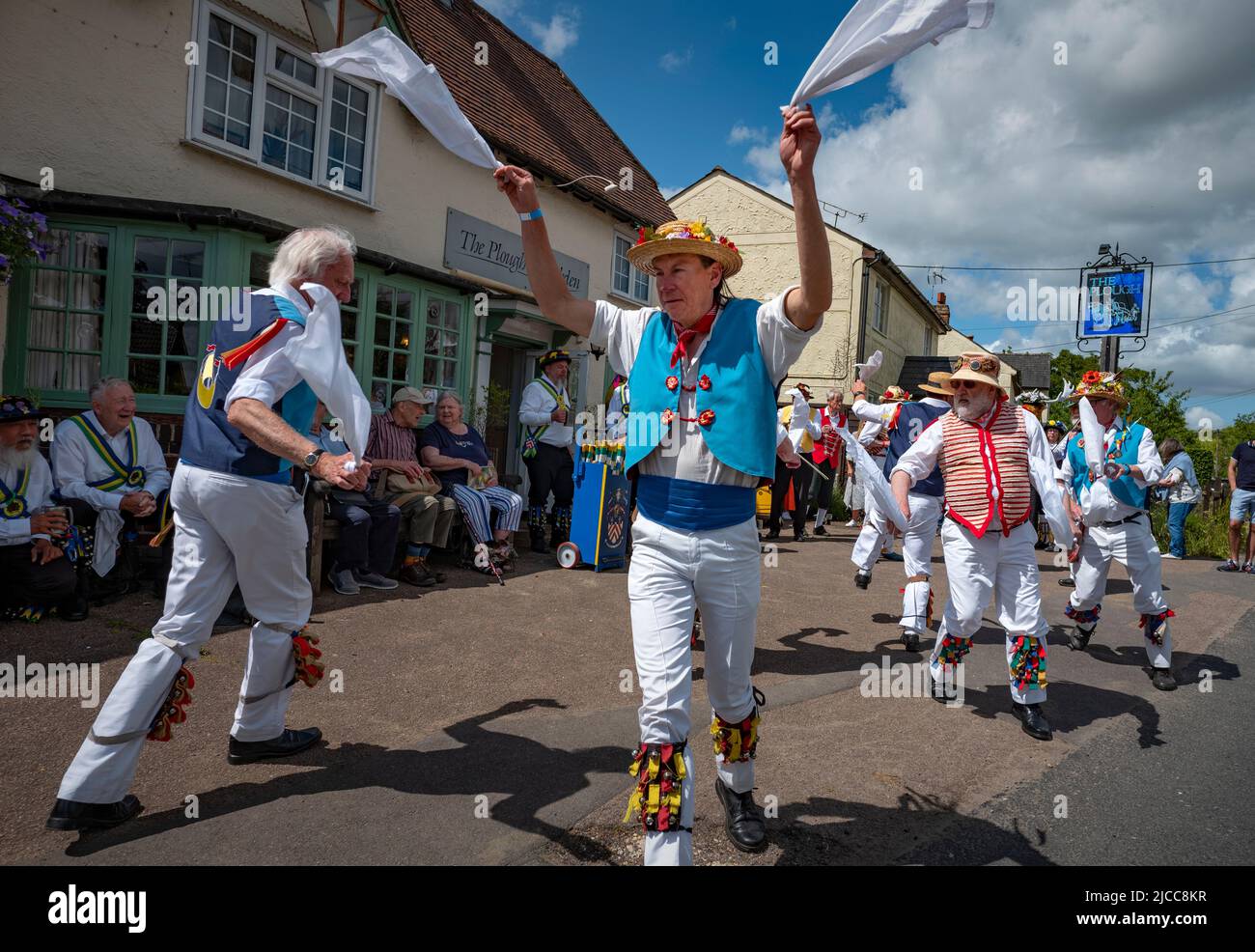 Thaxted, Essex, UK. 11th June 2022.  East Suffolk Morris side in blue and Thaxted side in red and white perform at the Plough Debden Essex. Fourteen Morris Dancing sides danced through 14 villages in north west Essex for the first time since Covid restrictions were lifted for the Thaxted Morris Weekend. The evening concluded just after 10pm when all st Credit: BRIAN HARRIS/Alamy Live News Stock Photo