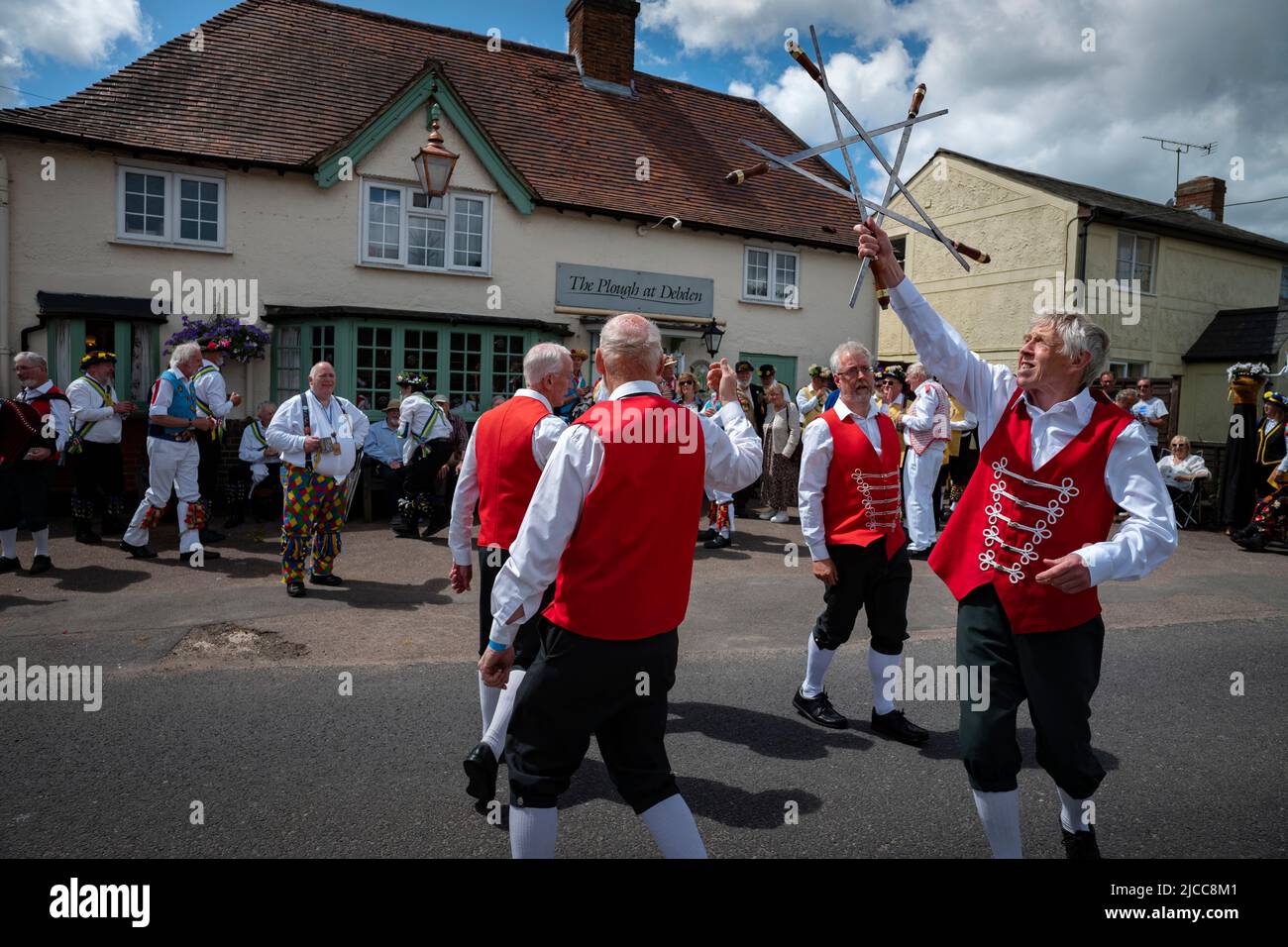 Thaxted, Essex, UK. 11th June 2022.  Claro Sword Morris side complete their dance with a intertwined set of swords. Fourteen Morris Dancing sides danced through 14 villages in north west Essex for the first time since Covid restrictions were lifted for the Thaxted Morris Weekend. The evening concluded just after 10pm when all street lights are turned o Credit: BRIAN HARRIS/Alamy Live News Stock Photo