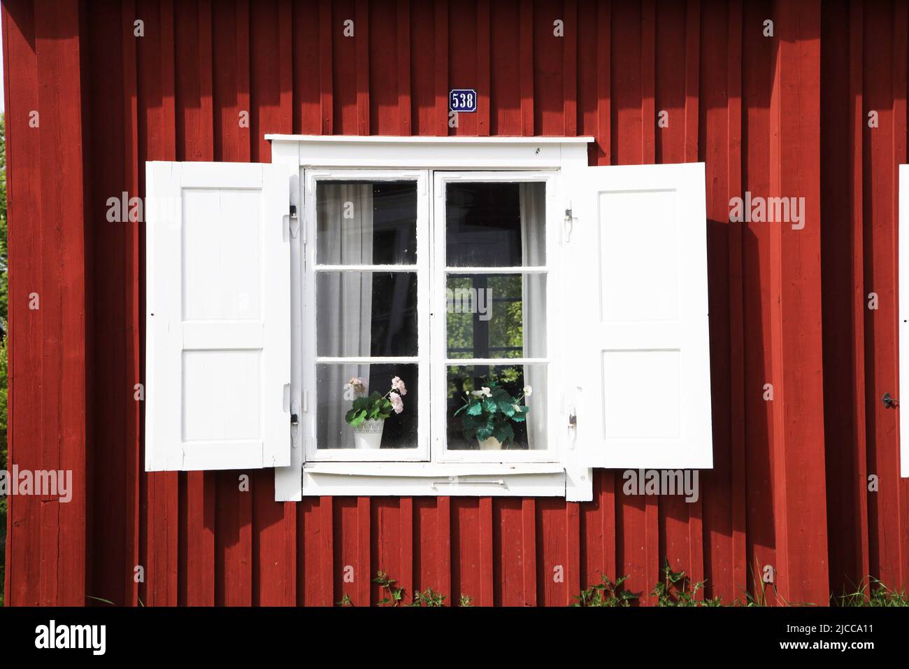 Gammelstad, Sweden. 08th June, 2022. A window of a cottage in typical Swedish color - also called Swedish red or Falun red - in Gammelstad, the old center of the city of Lulea. Credit: Steffen Trumpf/dpa/Alamy Live News Stock Photo