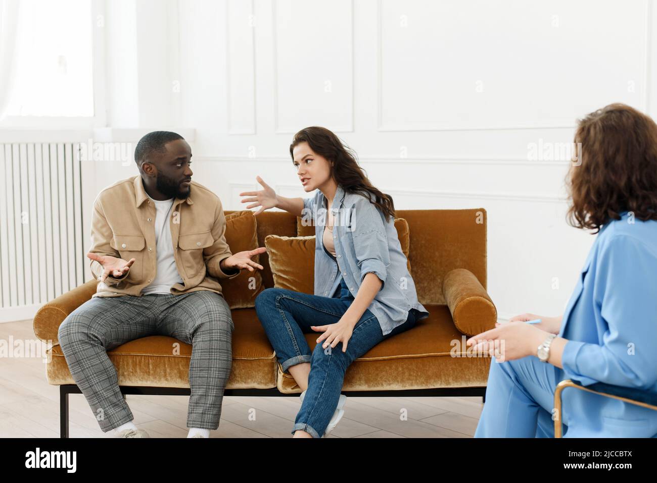 Stressed unhappy millennial Caucasian and African American couple have relationship problems