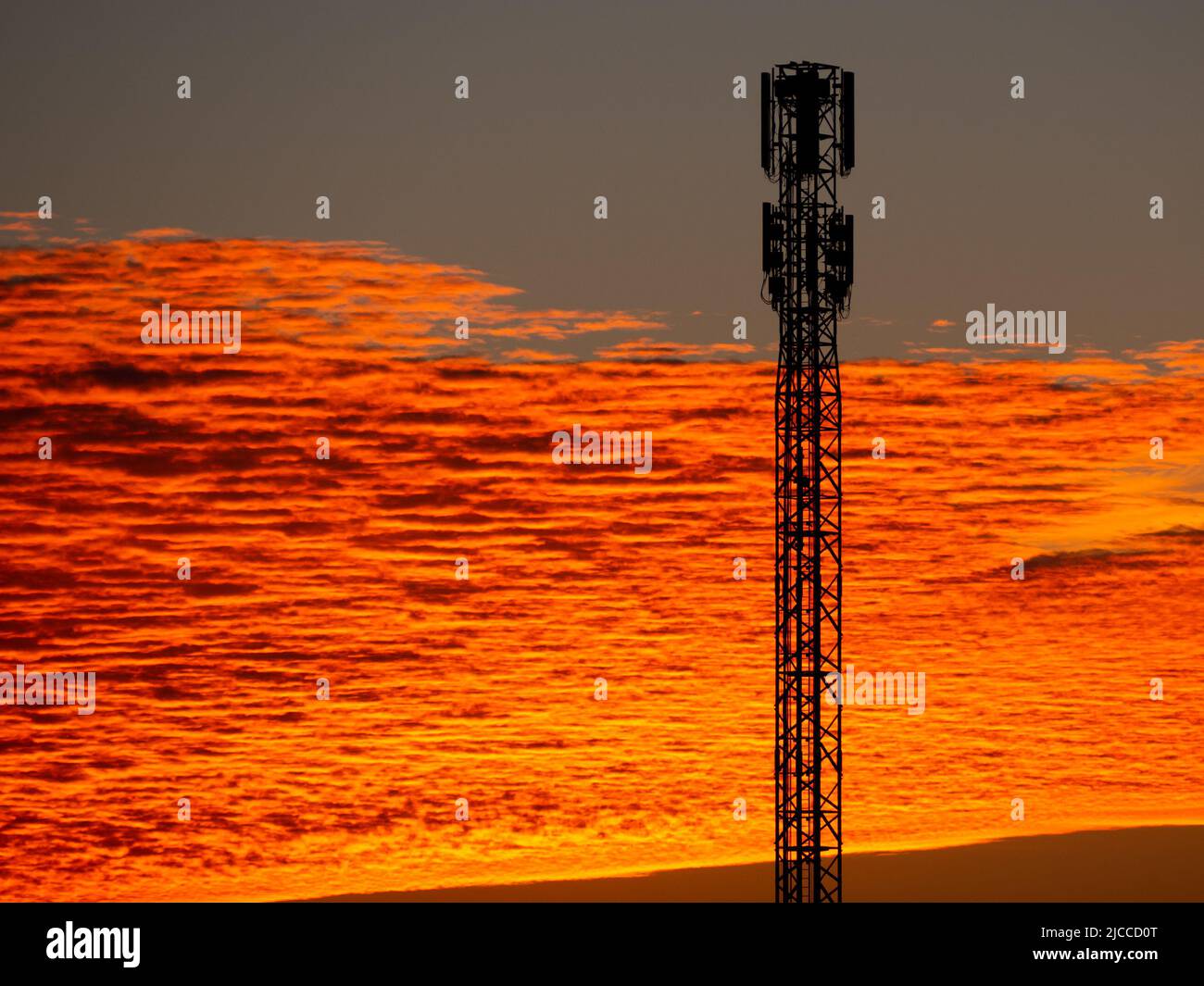 Antenna in an orange sky color at dawn. Stock Photo