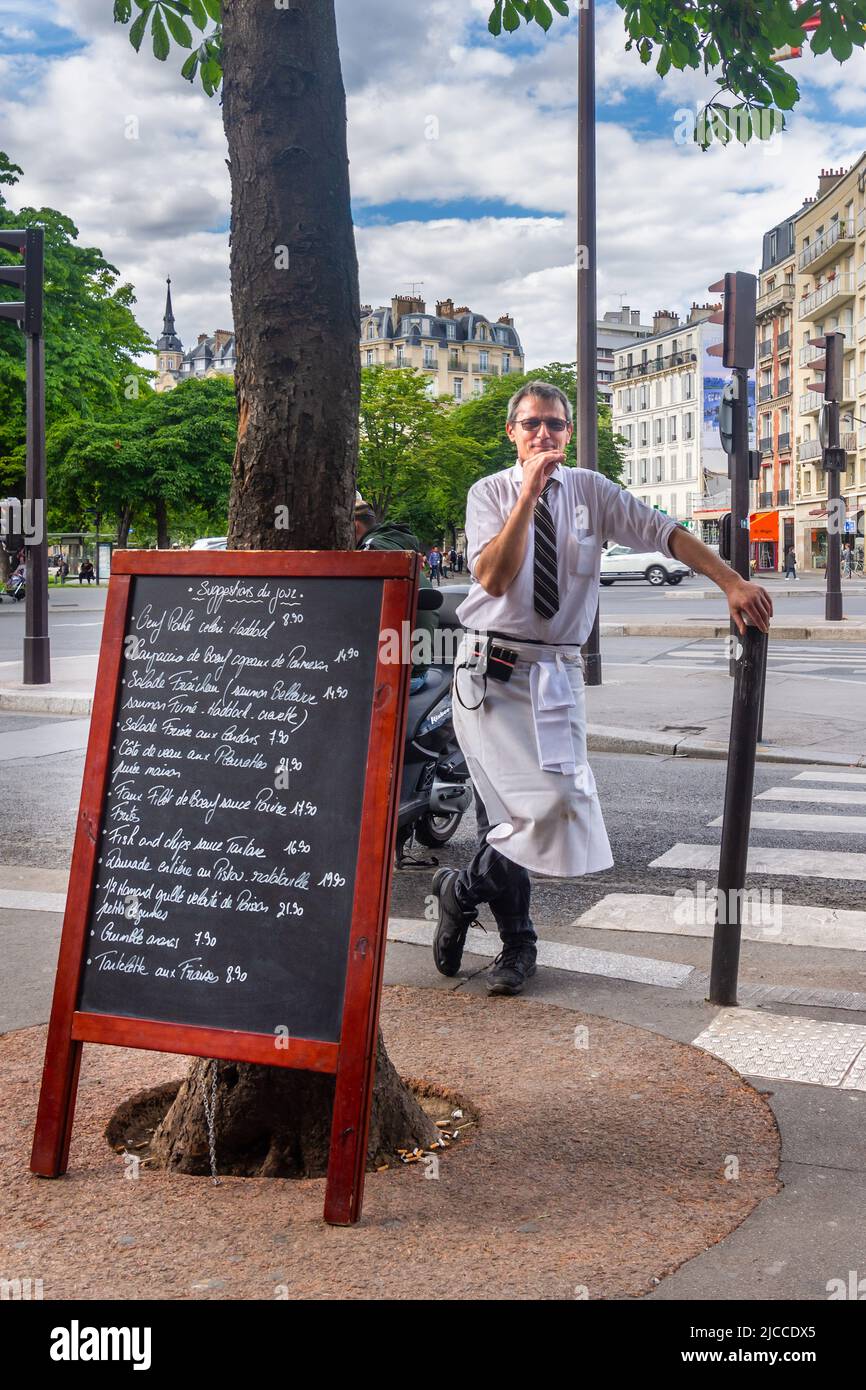 Waiter at Le Dalou bar restaurant , Place de la Nation, Paris 12th, having a smoke break. Stock Photo