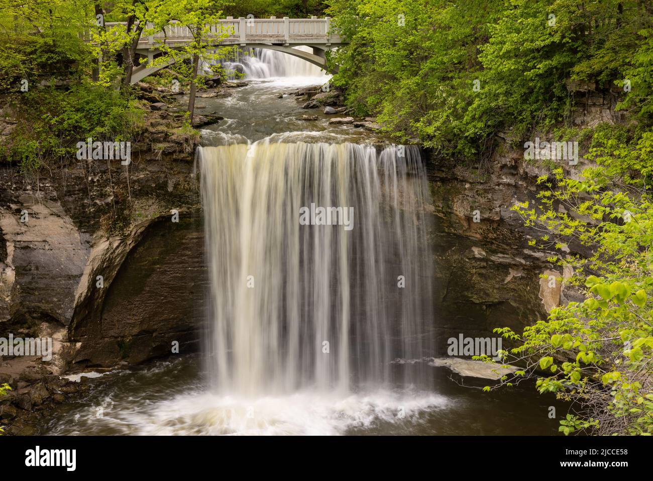 Minneopa Falls A waterfall under a footbridge in the woods Stock
