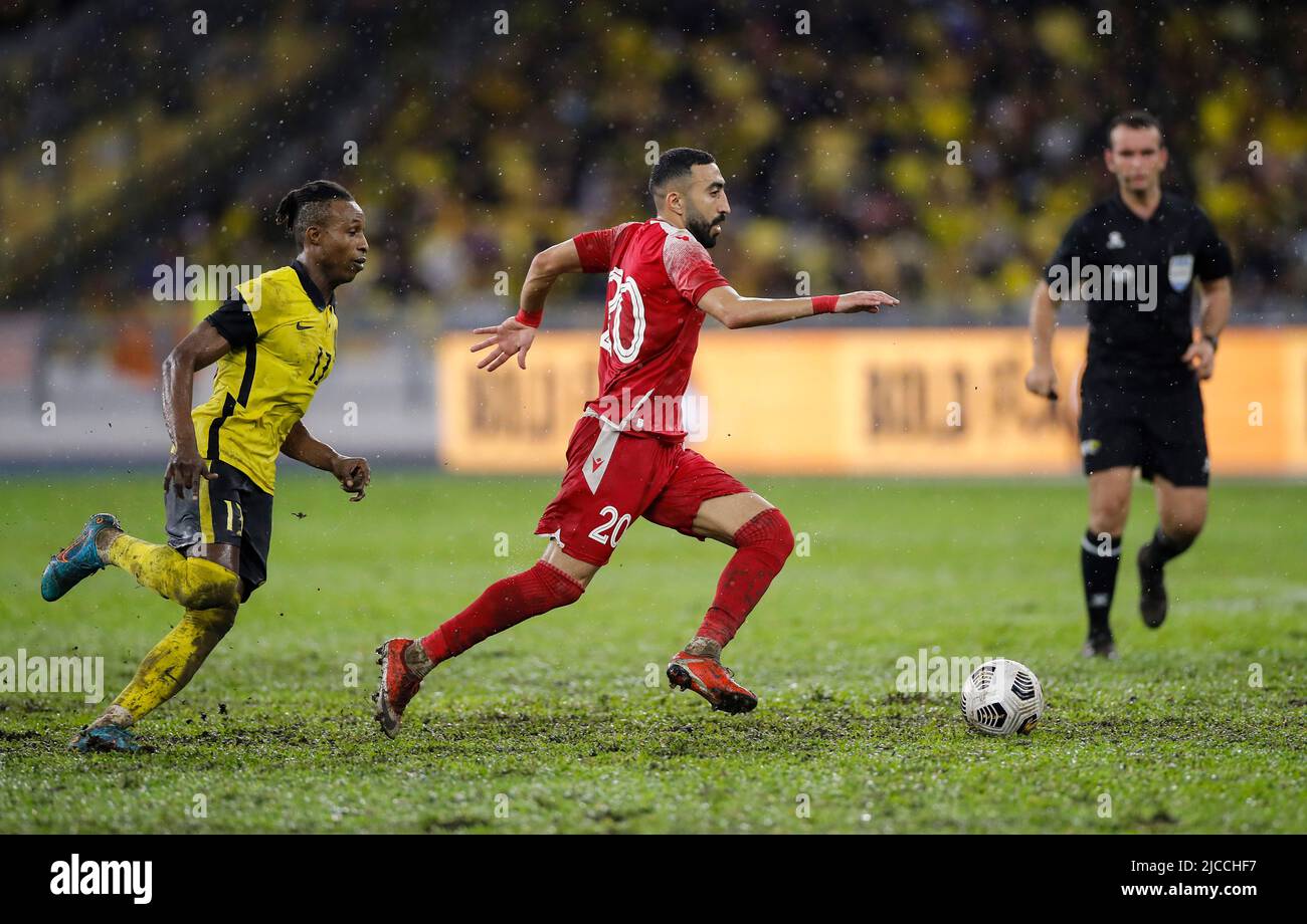 Kuala Lumpur, Malaysia. 11th June, 2022. Mohamadou Sumareh (L) of Malaysia and Mahdi Faisal Alhumaidan of Bahrain in action during the AFC Asian Cup 2023 qualifiers match between Malaysia and Bahrain at the National Stadium Bukit Jalil. Final score; Bahrain 2:1 Malaysia. Credit: SOPA Images Limited/Alamy Live News Stock Photo