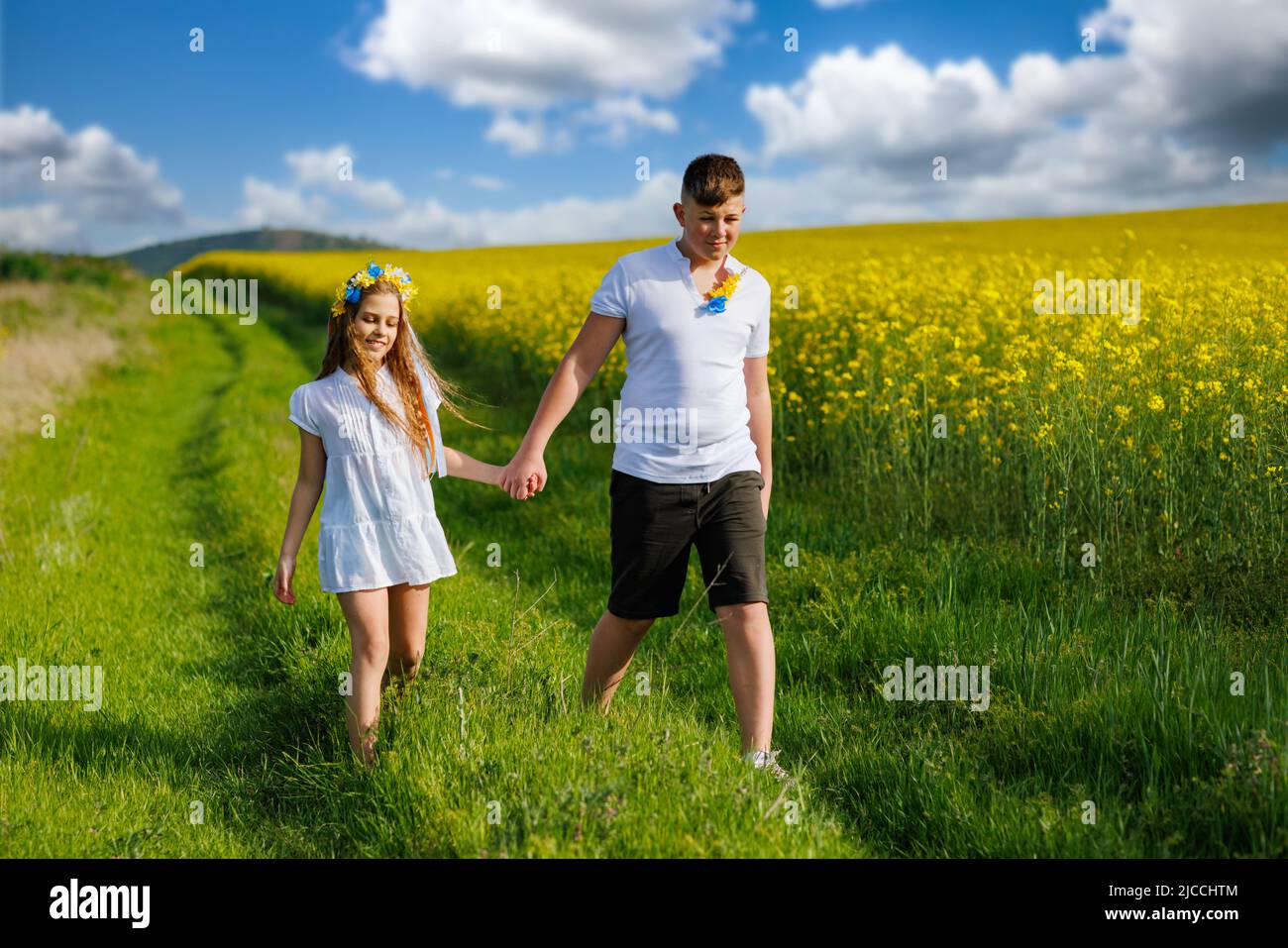Front view of happy carefree native children: older teenage brother and ...