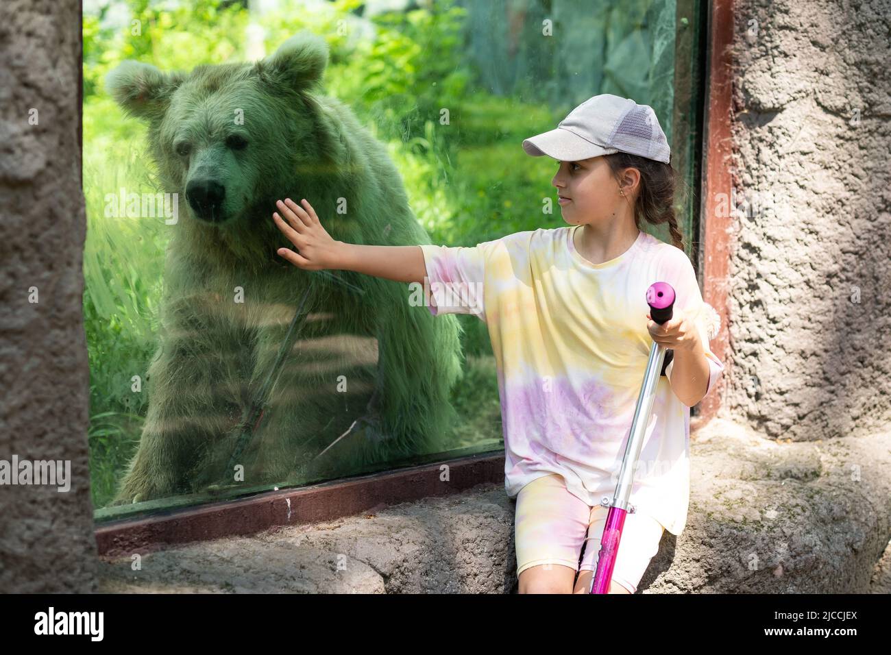 little girl on a scooter at the zoo Stock Photo Alamy