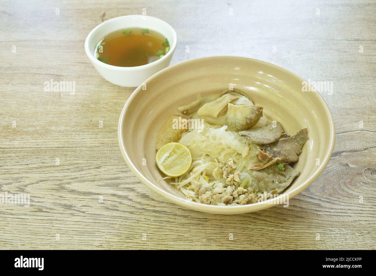 boiled dry thin rice noodles with entrails and fish line on bowl Stock