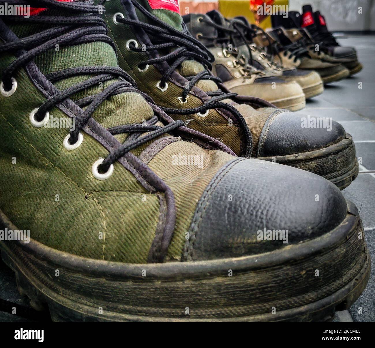 a close up shot of army training boot, shoes lined up after a run. Uttarakhand India. Stock Photo