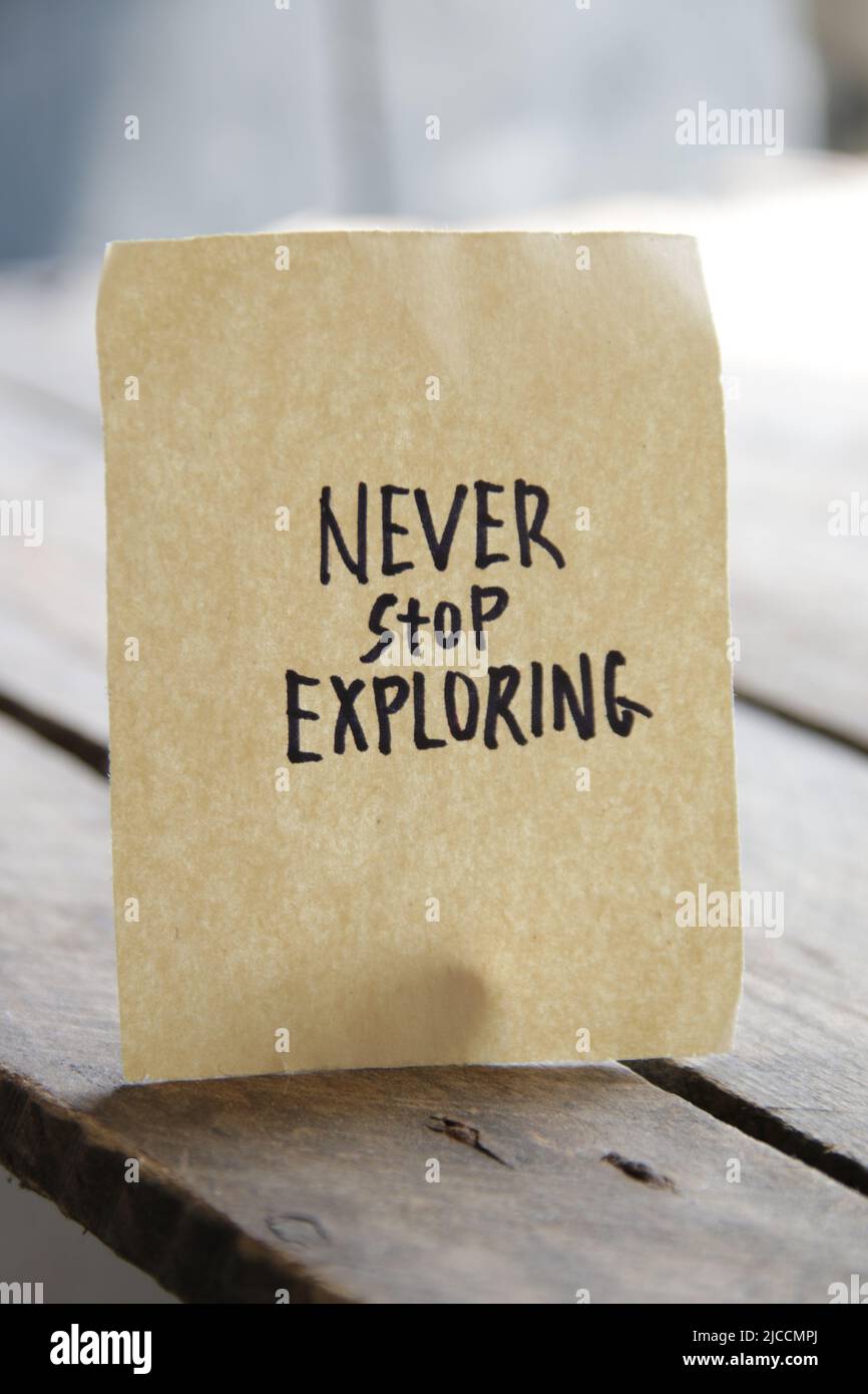 Never stop exploring idea. Writing on a piece of paper Stock Photo