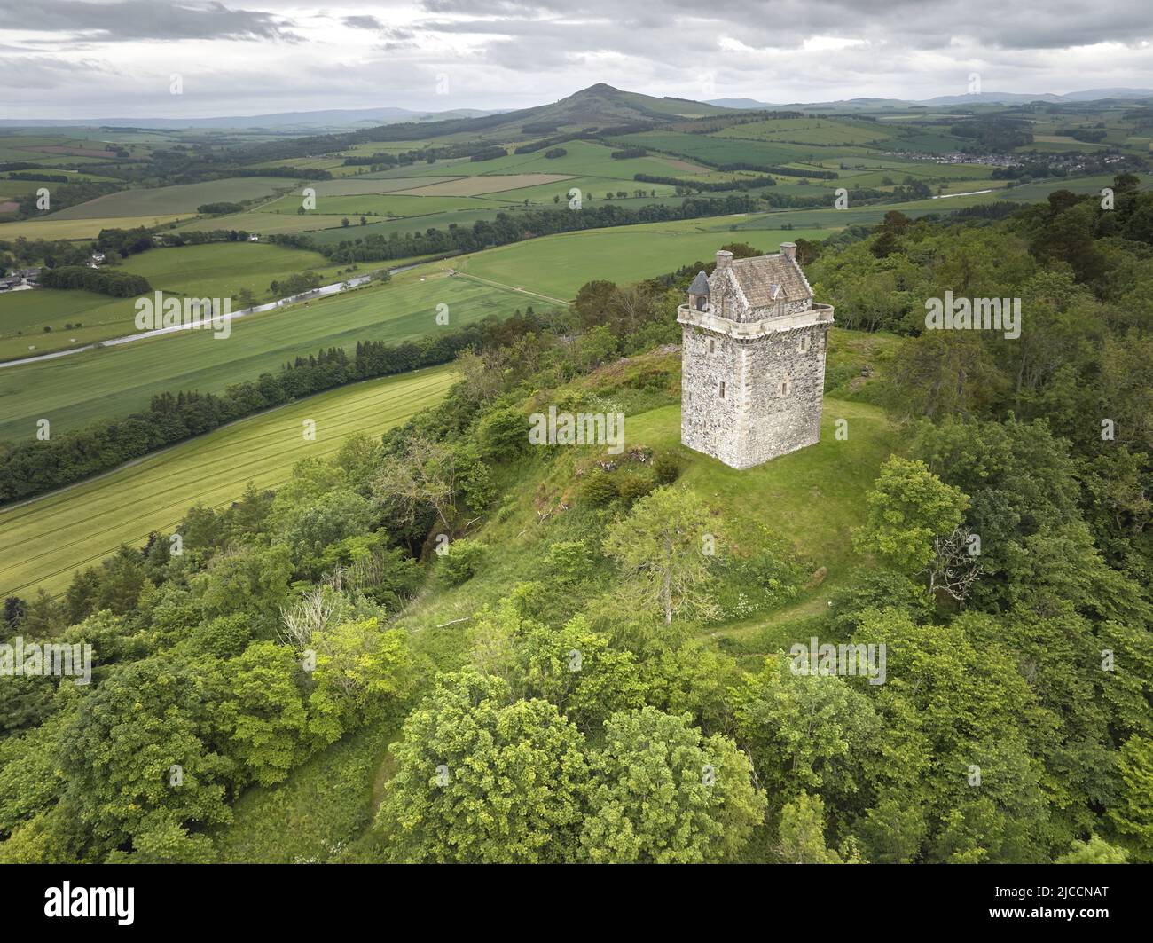 Aerial shot of Fatlips Castle a peel tower in Roxburghshire, in the Scottish Borders. Situated at the top of Minto Crags, above the River Teviot, Stock Photo