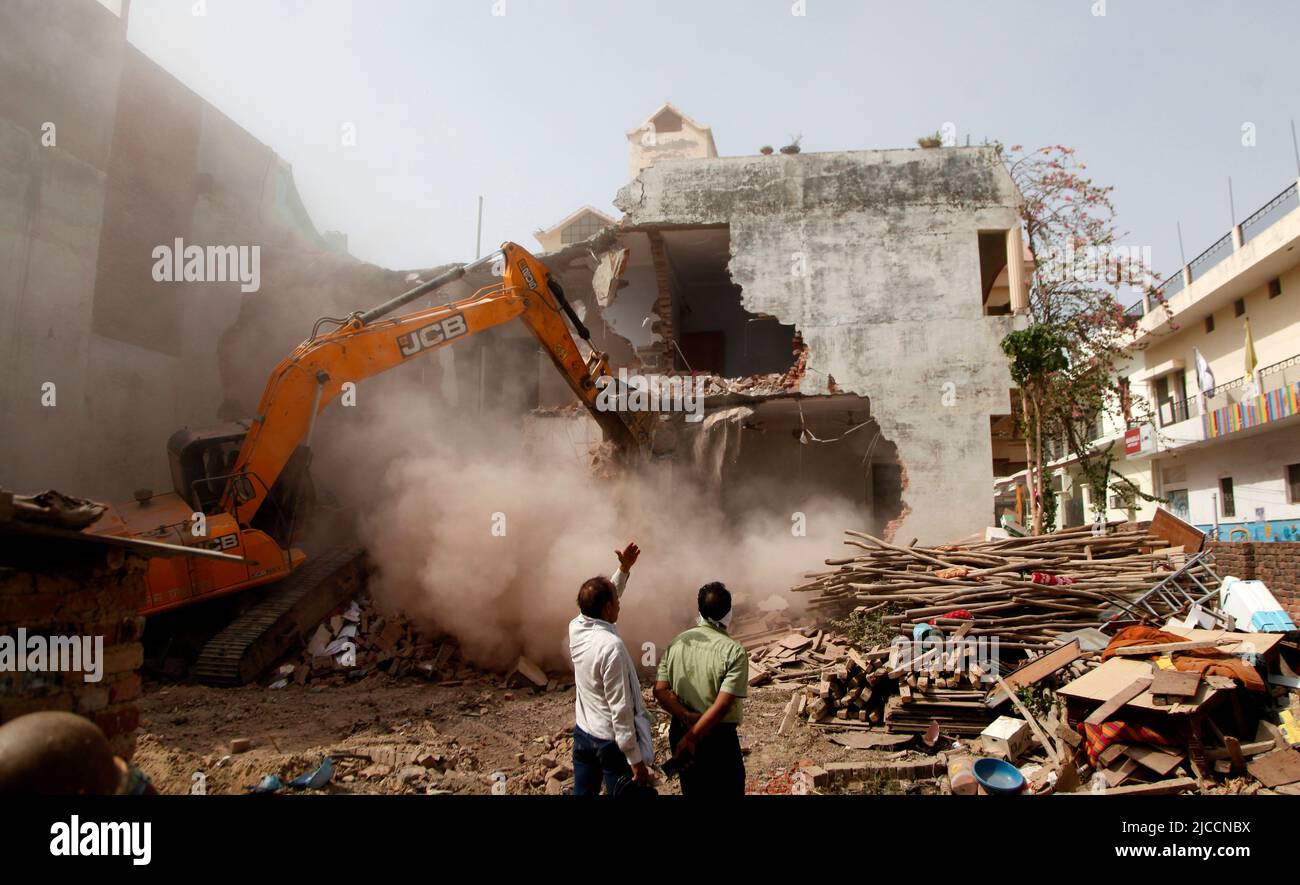 Prayagraj, India. 12th June, 2022. Bulldozer being used by Prayagraj Development Authority administration to demolish the illegally constructed residence of main conspirator of violent protest and stone pelting on sunday in Prayagraj, India. Protests erupted in several parts of the country on Friday (10 June 2022) against Bharatiya Janata Party spokesperson now suspended Nupur Sharma's derogatory comment's on Prophet Muhammad. Protests in Uttar Pradesh's Prayagraj and other state turned violent where police had to resort to lathi-charge. Credit: Anil Shakya/Alamy Live News Stock Photo