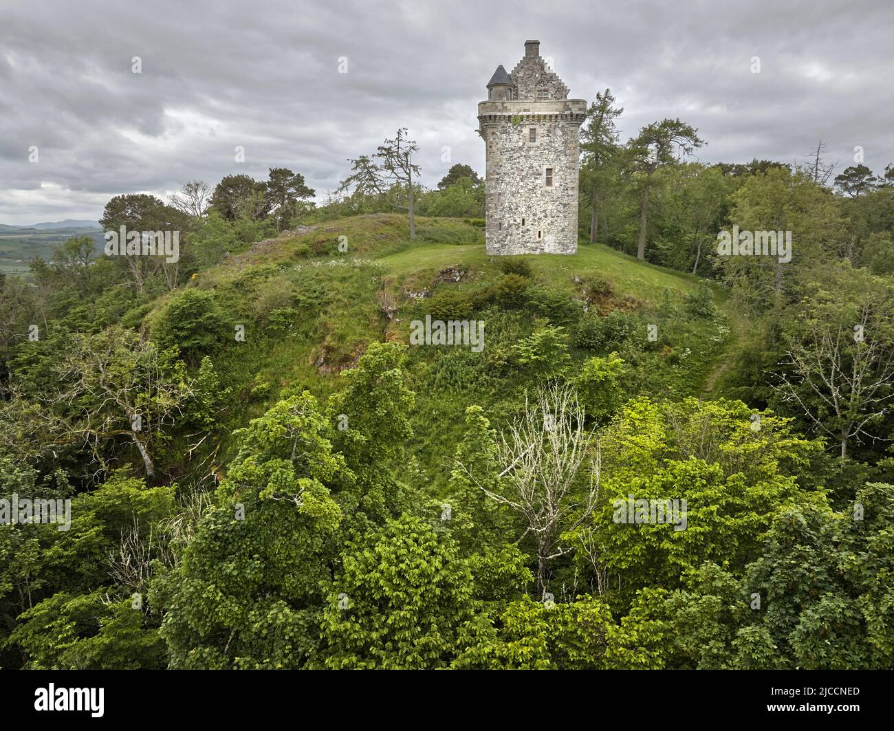 Aerial shot of Fatlips Castle a peel tower in Roxburghshire, in the Scottish Borders. Situated at the top of Minto Crags, above the River Teviot, Stock Photo