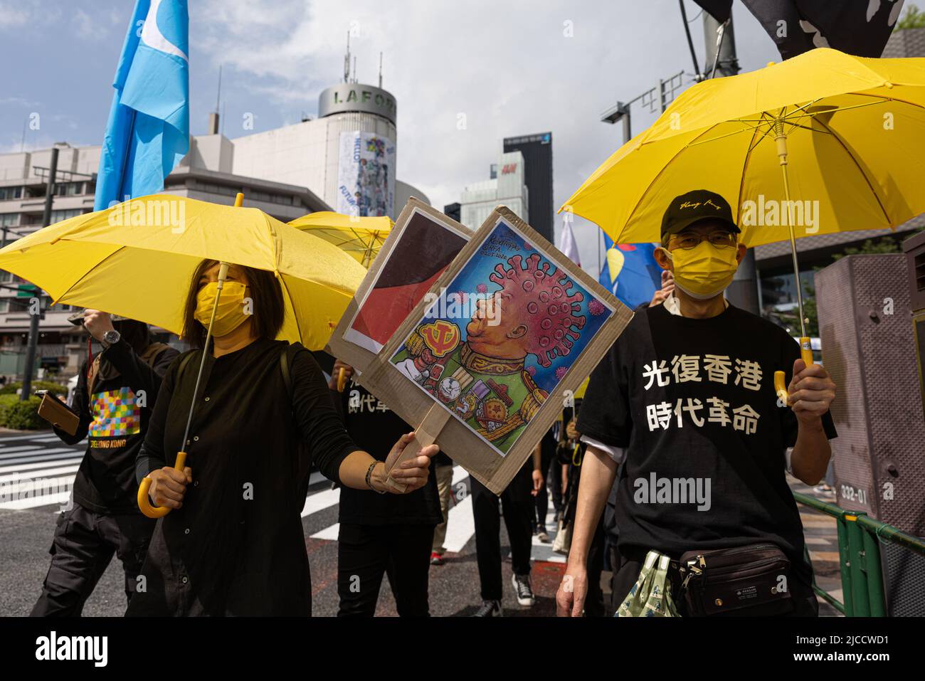 Demonstrator holds up a placard with Xi Jinping while walking through the streets in Omote-Sando during the three year anniversary of the June 12, 2019 Hong Kong protest. June 12, 2022 marks the three year anniversary of the June 12, 2019 Hong Kong protest. It was sparked by the controversial Fugitive Offenders amendment bill also known as extradition bill. Several thousands of citizens of Hong Kong demonstrated against the bill and it was the beginning of the Hong Kong protests (2019-2020). (Photo by Stanislav Kogiku/SOPA Images/Sipa USA) Stock Photo