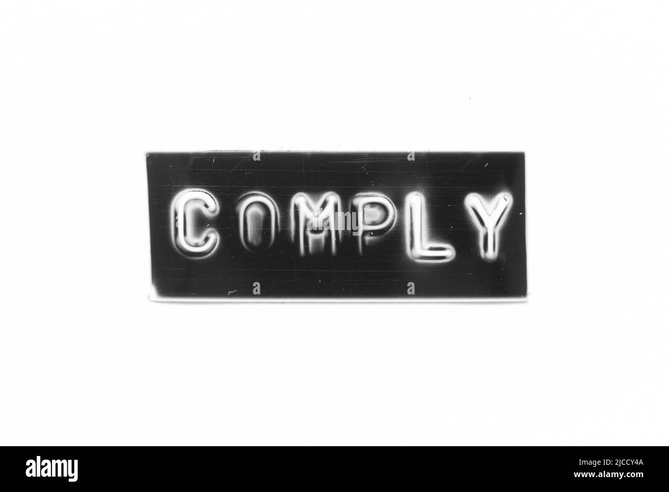 Black color banner that have embossed letter with word comply on white ...
