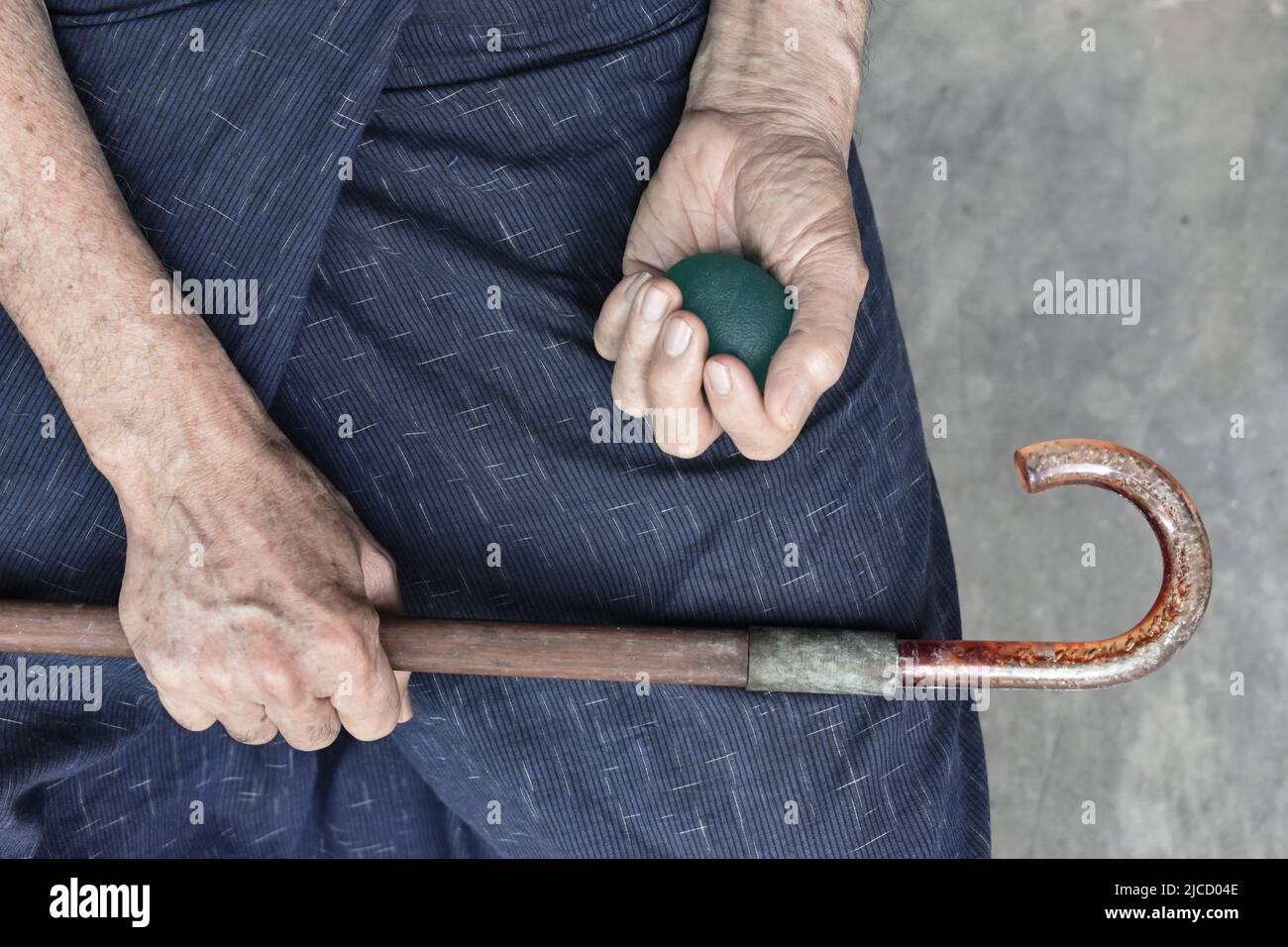 Southeast asian, Chinese old man gripping hand exercise elastic ball